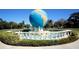 A globe water fountain surrounded by a small decorative fence at 2253 Norwegian Dr # 27, Clearwater, FL 33763