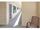 Well-lit hallway with a comfortable chair and unit doors, offering a sense of community and convenience at 2253 Norwegian Dr # 27, Clearwater, FL 33763