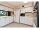 Bright kitchen featuring white cabinets, appliances, and tile flooring for a clean, classic look at 2253 Norwegian Dr # 27, Clearwater, FL 33763