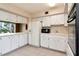 Bright kitchen featuring white cabinets, appliances, and tile flooring for a clean, classic look at 2253 Norwegian Dr # 27, Clearwater, FL 33763
