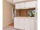 Eat-in kitchen with white cabinets, solid surface countertops, and lots of natural light at 2253 Norwegian Dr # 27, Clearwater, FL 33763