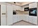 A well-lit kitchen with white cabinets and appliances at 2253 Norwegian Dr # 27, Clearwater, FL 33763