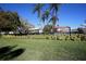 A lawn with palm trees and a black fence at 2253 Norwegian Dr # 27, Clearwater, FL 33763
