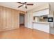 View of living room shows breakfast bar to kitchen and wood paneling on walls at 2253 Norwegian Dr # 27, Clearwater, FL 33763