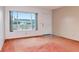 Bright living room with a large window overlooking lush greenery, offering a serene and peaceful environment at 2253 Norwegian Dr # 27, Clearwater, FL 33763