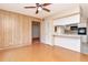View of living room shows breakfast bar to kitchen and wood paneling on walls at 2253 Norwegian Dr # 27, Clearwater, FL 33763
