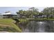 Scenic view of a tranquil pond with a covered pavilion, fountain, and lush green surroundings at 2253 Norwegian Dr # 27, Clearwater, FL 33763