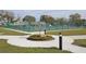 Outdoor tennis courts surrounded by a green fence, manicured lawns, and landscaping in a serene environment at 2253 Norwegian Dr # 27, Clearwater, FL 33763