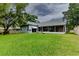 Backyard features a spacious lawn and a screened-in lanai at 22946 Brownwood Ct, Land O Lakes, FL 34639