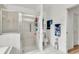 Well-lit bathroom with glass-enclosed shower, tile floors, and modern fixtures at 22946 Brownwood Ct, Land O Lakes, FL 34639