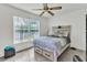 Bedroom featuring modern ceiling fan, natural light, and neutral tones at 22946 Brownwood Ct, Land O Lakes, FL 34639