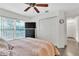 Bright bedroom features wood-look floors, ceiling fan, and double door closet at 22946 Brownwood Ct, Land O Lakes, FL 34639
