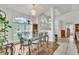 Bright dining room featuring a stylish dining set, chandelier, and arched window views at 22946 Brownwood Ct, Land O Lakes, FL 34639
