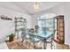 Bright dining area featuring a glass top dining table and decorative furniture at 22946 Brownwood Ct, Land O Lakes, FL 34639
