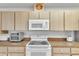 Well-maintained kitchen with light-colored cabinets and appliances at 22946 Brownwood Ct, Land O Lakes, FL 34639