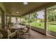Screened lanai with neutral carpet, seating, and backyard views at 22946 Brownwood Ct, Land O Lakes, FL 34639