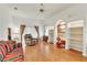 Bright living room features built-in shelving, wood floors, and a comfortable seating area at 22946 Brownwood Ct, Land O Lakes, FL 34639