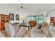 Bright living room with plush seating, hardwood flooring, and natural light at 22946 Brownwood Ct, Land O Lakes, FL 34639