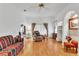 Bright living room with hardwood flooring, fan, and multiple seating options at 22946 Brownwood Ct, Land O Lakes, FL 34639