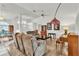 Bright living room with plush seating, piano, and wood floors create a cozy and inviting atmosphere at 22946 Brownwood Ct, Land O Lakes, FL 34639