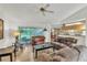 Bright living room with wood floors, furniture, ceiling fan, and view to backyard at 22946 Brownwood Ct, Land O Lakes, FL 34639