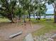 Park view of playground with swings and lake views at the community park at 22946 Brownwood Ct, Land O Lakes, FL 34639