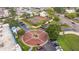 Aerial view of gated entrance to the community, revealing tennis courts and a central roundabout with parking at 2424 W Tampa Bay Blvd # G204, Tampa, FL 33607