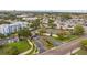 Aerial view of the gated community entrance and tennis courts, showcasing its lush landscaping and well-maintained facilities at 2424 W Tampa Bay Blvd # G204, Tampa, FL 33607