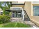Backyard patio featuring white railing stairs and tropical plants at 2424 W Tampa Bay Blvd # G204, Tampa, FL 33607