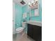 Stylish bathroom with modern vanity, sink, and toilet with teal walls at 2424 W Tampa Bay Blvd # G204, Tampa, FL 33607