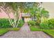 Inviting condo exterior with lush landscaping and a charming brick walkway leading to the entrance at 2424 W Tampa Bay Blvd # G204, Tampa, FL 33607