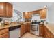 Well-equipped kitchen with wood cabinets, stainless steel appliances, and granite countertops at 2424 W Tampa Bay Blvd # G204, Tampa, FL 33607