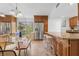 Bright kitchen with stainless steel refrigerator, breakfast bar, and dining area with large window view at 2424 W Tampa Bay Blvd # G204, Tampa, FL 33607