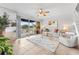 Inviting living room with tile floors, ceiling fan, sliding glass doors to the balcony, and neutral decor at 2424 W Tampa Bay Blvd # G204, Tampa, FL 33607