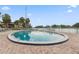 Community pool with surrounding patio, water views, and mature landscaping at 2424 W Tampa Bay Blvd # G204, Tampa, FL 33607