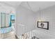 Bright stairwell with modern art and view of the waterfront balcony at 2424 W Tampa Bay Blvd # G204, Tampa, FL 33607