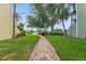 Brick walkway through a green lawn with trees, leading to the complex at 2424 W Tampa Bay Blvd # G204, Tampa, FL 33607