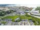 A wide aerial shot of a townhome community near the bay with roads and commercial areas in the background at 2432 Golden Pasture Cir, Clearwater, FL 33764