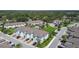 Aerial view showcasing the community featuring townhomes, green spaces, and a communal swimming pool at 2432 Golden Pasture Cir, Clearwater, FL 33764