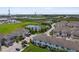 An attractive aerial view of townhomes near a pond and green space, with a distant view of the ocean at 2432 Golden Pasture Cir, Clearwater, FL 33764