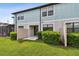 A fenced-in back patio is the perfect place to relax in this unit, with small bushes and a sliding door at 2432 Golden Pasture Cir, Clearwater, FL 33764