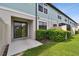 The back of the unit showcases a private patio with a sliding glass door and small bushes at 2432 Golden Pasture Cir, Clearwater, FL 33764
