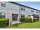The back of the unit features a private patio with greenery providing a sense of seclusion at 2432 Golden Pasture Cir, Clearwater, FL 33764