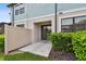 View of the back patio, with a sliding glass door to the unit and a privacy fence at 2432 Golden Pasture Cir, Clearwater, FL 33764