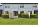 This unit features a back patio, short privacy fence, and neatly manicured green bushes at 2432 Golden Pasture Cir, Clearwater, FL 33764