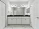 Contemporary bathroom featuring double sinks, modern cabinets, and marble flooring for a sleek design at 2432 Golden Pasture Cir, Clearwater, FL 33764