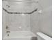 Tiled shower and tub combo, featuring modern fixtures and tile accents at 2432 Golden Pasture Cir, Clearwater, FL 33764
