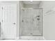 Modern bathroom showcasing a glass-enclosed shower with marble-look tile and contemporary fixtures at 2432 Golden Pasture Cir, Clearwater, FL 33764
