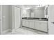 Bright bathroom features a double vanity, sleek cabinets, and modern lighting for a spa-like feel at 2432 Golden Pasture Cir, Clearwater, FL 33764