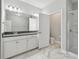 Well-lit bathroom featuring double vanity, ample storage, and marble look tiles for a clean design at 2432 Golden Pasture Cir, Clearwater, FL 33764